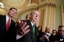 Senate Majority Leader Mitch McConnell of Ky., joined at left by Sen. John Barrasso, R-Wyo., speaks with reporters after meeting with Vice President Mike Pence as Republicans roll out their Obamacare replacement plan, March 7, 2017.