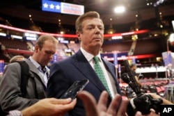 FILE - Paul Manafort talks to reporters on the floor of the Republican National Convention at Quicken Loans Arena in Cleveland.