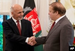 Pakistan's Prime Minister Nawaz Sharif, right, receives Afghan President Ashraf Ghani at the prime minister house in Islamabad, Pakistan, Saturday, Nov. 15, 2014.