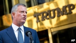 FILE - New York Mayor Bill de Blasio holds a news conference in front of Trump Tower following a meeting with President-elect Donald Trump, Nov. 16, 2016, in New York.