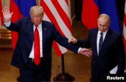 U.S. President Donald Trump and Russian President Vladimir Putin react at the end of the joint news conference after their meeting in Helsinki, Finland, July 16, 2018.