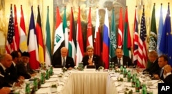 FILE - Russia's Foreign Minister Sergei Lavrov, top right, U.S. Secretary of State John Kerry, top center, and other foreign ministers attend a meeting in Vienna, Austria, Nov. 14, 2015, to find a way to resolve the conflict in Syria.