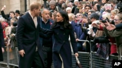 FILE - Britain's Prince Harry and his fiancee Meghan Markle arrive at the Terrence Higgins Trust World AIDS Day charity fair, in Nottingham, England, Dec. 1, 2017.