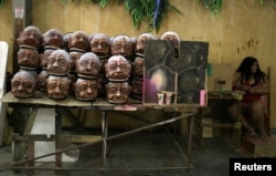 Parts of carnival floats from Imperatriz Leopoldinense samba school, depicting native people from the Amazon jungle, are seen at the school's carnival production headquarters in Rio de Janeiro, Brazil, Feb. 9, 2017.