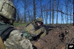 FILE - Ukrainian military servicemen control their position during a cease-fire outside Avdiivka, eastern Ukraine, April 16, 2016.