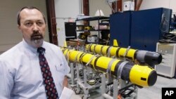 FILE - A pair of unmanned underwater vehicles (UUV) are pictured in a lab at the Naval Undersea War Center in Middletown, R.I.