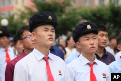 FILE - People watch a news broadcast on a missile launch in Pyongyang, North Korea, July 29, 2017. North Korean leader Kim Jong Un said the second flight test of an intercontinental ballistic missile demonstrated his country could hit the U.S. mainland.