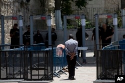 A Palestinian man walks towards a metal detector at the Al Aqsa Mosque compound in Jerusalem's Old City, July 19, 2017. A dispute over metal detectors has escalated into a new showdown between Israel and the Muslim world.