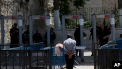 A Palestinian man walks towards a metal detector at the Al Aqsa Mosque compound in Jerusalem's Old City, July 19, 2017. A dispute over metal detectors has escalated into a new showdown between Israel and the Muslim world.
