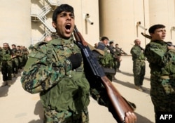 Syrian fighters attend their graduation ceremony near Syria's northeastern city of Hasakah, Jan. 20, 2018.