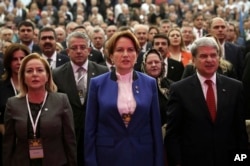 FILE - Meral Aksener, a former interior minister and deputy parliament speaker, center, attends her party's first meeting in Ankara, Turkey, Oct. 25, 2017. The new party of Aksener, 61, hopes to challenge President Recep Tayyip Erdogan in elections set for 2019.