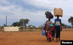 FILE - South Sudan refugees arrive at the U.N. High Commissioner for Refugees-managed refugee reception point at Elegu, in Amuru district of the northern region near the South Sudan-Uganda border, Aug. 20, 2016.