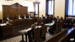 Italian journalists Gianluigi Nuzzi and Emiliano Fittipaldi (background, center) and Vatican officials are seen on the defendants' bench at their trial inside the Vatican, Nov. 24, 2015.