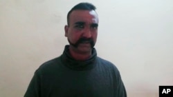 FILE - An image taken from video released by Pakistan's military, shows what Pakistan claims to be an Indian pilot who was captured after his plane was shot down by Pakistan's Air Force in the Pakistani-controlled part of Kashmir.