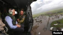 Australian Prime Minister Malcolm Turnbull looks at damaged and flooded areas from aboard an Australian Army helicopter after Cyclone Debbie passed through the area near the town of Bowen, south of the northern Queensland town of Townsville in Australia,March 30, 2017.