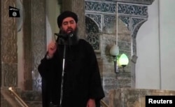 FILE - Image taken from recently released video shows man purported to be Abu Bakr al-Baghdadi, ISIL's reclusive leader, making what would be his first public appearance at a mosque in the center of Iraq's second city, Mosul July 5, 2014.