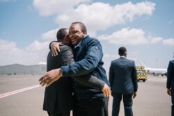Ethiopian Prime Minister Abiy Ahmed (L) welcomes Kenyan President Uhuru Kenyatta at the Bole International Airport in Addis Ababa, Ethiopia, Nov. 14, 2021.