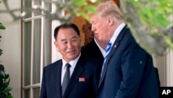 President Donald Trump talks with Kim Yong Chol, former North Korean military intelligence chief and one of leader Kim Jong Un's closest aides, as they walk from their meeting in the Oval Office of the White House in Washington, June 1, 2018.