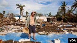 Billy “The Kid” Quinn, 48, assesses the damage atop a blue slab where his home used to be in Islamorada's Seabreeze Trailer Park. (R. Taylor/VOA)