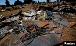 FILE - A bicycle lies amongst the debris of houses destroyed in post election violence in the village of Rukuini near Eldoret, northwest of Nairobi, Jan. 7, 2008.