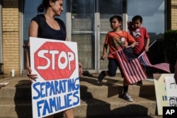 People participate in a protest against recent U.S. immigration policy that separates children from their families when they enter the United States as undocumented immigrants, in front of a Homeland Security facility in Elizabeth, New Jersey, June 17, 2018.