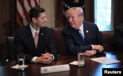 FILE - U.S. President Donald Trump talks with House Speaker Paul Ryan, R-Wis., in the Cabinet Room of the White House in Washington, Nov. 2, 2017.