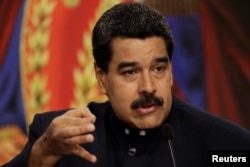 Venezuelan President Nicolas Maduro talks to reporters during a news conference at Miraflores Palace in Caracas, Aug. 22, 2017.