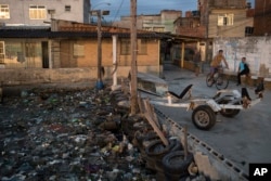 Houses stand next to the heavily polluted shore of Guanabara Bay in Rio de Janeiro, Brazil, July 30, 2016.
