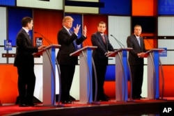 Republican presidential candidate Donald Trump, second from left, gestures as Sen. Marco Rubio, R-Fla., Sen. Ted Cruz, R-Texas, and Ohio Gov. John Kasich look on at a Republican presidential primary debate in Detroit, March 3, 2016.