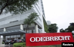 Federal police cars are parked in front of the headquarters of Odebrecht, a large private Brazilian construction firm, in Sao Paulo, Brazil, June 19, 2015.