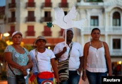 Activists take part during a demonstration to protest violence against women in Cartagena, Colombia, Oct. 27, 2016.