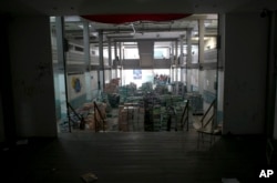 A pile of 30,000 unopened textbooks block the auditorium stage, a favorite make-out spot for students at a public high school in Caracas, Venezuela, May 31, 2016.