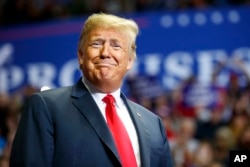 President Donald Trump looks to the cheering crowd as he arrives to speak at a rally at Allen County War Memorial Coliseum, Nov. 5, 2018, in Fort Wayne, Indiana.