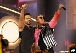 FILE - This April 27, 2017, photo shows singers Luis Fonsi, left, and Daddy Yankee during the Latin Billboard Awards in Coral Gables, Florida.