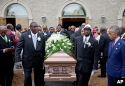 The Rev. Al Sharpton (R) watches as the casket of Ethel Lance is carried to a hearse following her funeral service, June 25, 2015, in North Charleston, S.C.