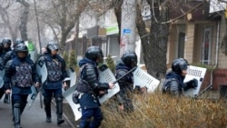 Riot police walk to block demonstrators during a protest in Almaty, Kazakhstan, Jan. 5, 2022.