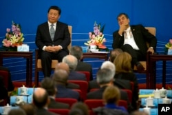 FILE - Chinese President Xi Jinping and Ecuador's President Rafael Correa, right attend the opening ceremony to a two-day meeting between China and Latin American and Caribbean countries held at the Great Hall of the People in Beijing, China, Jan. 8, 2015.