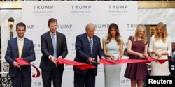 (L-R) Donald Trump Jr., Eric Trump, then-Republican U.S. presidential nominee Donald Trump, Melania Trump, Tiffany Trump and Ivanka Trump attend an official ribbon-cutting ceremony at the new Trump International Hotel in Washington D.C., Oct. 26, 2016.