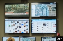 FILE - After reports of threats, Mall of America Director of Security Major Doug Reynolds explains the social media monitoring team during a tour of the mall's security systems in Bloomington, Minn., Feb. 23, 2015.