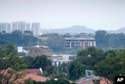 Part of the facade of Capella Hotel is seen in the center of the photo, on Sentosa Island in Singapore, June 6, 2018, ahead of a planned summit Tuesday, June 12, in Singapore between President Donald Trump and North Korean autocrat Kim Jong Un.