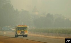 A firetruck makes its way through the Chateau St. Jean winery, Oct. 10, 2017, in Kenwood, Calif.