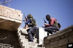 FILE - Militants from the Kurdistan Workers' Party, or PKK, run as they attack Turkish security forces in Nusaydin, Turkey, March 1, 2016.