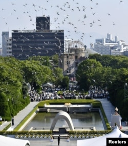 Doves fly over the Peace Memorial Park with the Atomic Bomb Dome in the background, at a ceremony in Hiroshima, western Japan, August 6, 2018, on the 73rd anniversary of the atomic bombing of the city. Mandatory credit Kyodo/via REUTERS
