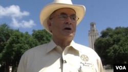 Ramiro Martinez, one of the officers who killed Whitman, speaks with the tower visible behind him. (G. Flakus/VOA)