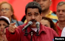 FILE - Venezuela's President Nicolas Maduro gives a speech at a rally against the United States and President Donald Trump, in Caracas, Aug. 14, 2017.