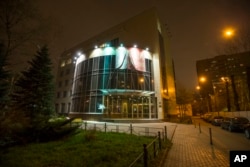 FILE - A man smokes a cigarette at the entrance of National anti-doping agency, RUSADA in Moscow, Russia, Monday, Nov. 9, 2015.