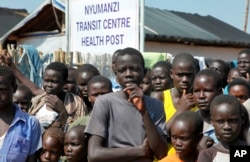 Refugees listen at a transit center for South Sudanese refugees in the remote northwestern district of Adjumani, near the border with South Sudan, in Uganda, in 2016. (AP)