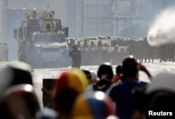 Demonstrators clash with riot security forces while rallying against Venezuela's President Nicolas Maduro in Caracas, Venezuela, June 10, 2017.