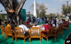 FILE - Myanmar State Counselor Aung San Suu Kyi, center, attends a peace talk with ethnic representatives during Union Day celebrations in Panglong, Myanmar, Feb. 12, 2017.