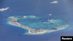 FILE - Chinese dredging vessels are purportedly seen in the waters around Mischief Reef in the disputed Spratly Islands in the South China Sea.